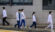 Medical workers walk outside a hospital in Seoul on March 19, 2024. Photo by ANTHONY WALLACE / AFP