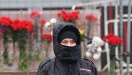 A police officer stands guard at a makeshift memorial in front of the Crocus City Hall, a day after a gun attack in Krasnogorsk, outside Moscow, on March 23, 2024. (Photo by Olga Maltseva / AFP)
 