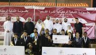Triumphant Al Janoubia players along with officials pose with the trophy. 