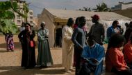 People queue at a polling station in a school in HLM Grand Medine on the outskirts of Dakar, on March 24, 2024 during the Senegalese presidential elections. (Photo by Carmen Abd Ali / AFP)