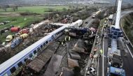 Police and emergency crews examine the debris of a crushed wagon on the second day after a train accident in the Tempi Valley near Larissa, Greece, March 2, 2023. Photo by Sakis MITROLIDIS / AFP