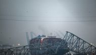 Part of the steel frame of the Francis Scott Key Bridge sits on top of the container ship Dali after the bridge collapsed in Baltimore, Maryland, on March 26, 2024. Photo by Kent Nishimura / AFP
