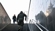 A wounded Ukrainian serviceman climbs stairs from an underground pedestrian way in the center of Kyiv on March 27, 2024, amid Russian invasion in Ukraine. Photo by Sergei SUPINSKY / AFP.