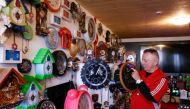 Werner Stechbarth sets a clock in his living room in Munich, southern Germany, on March 22, 2024. Photo by Christof STACHE / AFP