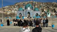 In this picture taken on March 25, 2024 Thai tourists pose for a group picture during their visit to the Kart-e-Sakhi Shrine in Kabul. (Photo by Wakil Kohsar / AFP) 