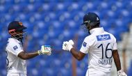 Dimuth Karunaratne (R) celebrates with teammate Kusal Mendis (L) after scoring a half century (50 runs) during the first day of the second Test cricket match between Bangladesh and Sri Lanka at the Zahur Ahmed Chowdhury Stadium in Chittagong on March 30, 2024. (Photo by MUNIR UZ ZAMAN / AFP)