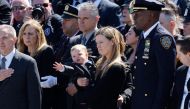 Stephanie Diller, the widow of NYPD officer Jonathan Diller, carries her son Ryan at the funeral of her husband at St. Rose of Lima R.C. Church on March 30, 2024 in Massapequa, New York. (Photo by Michael M. Santiago / GETTY IMAGES NORTH AMERICA / Getty Images via AFP)
