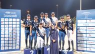 The podium winners of the medium tour event (left), and the medium tour team event, pose for a photograph with Deputy Head of Sports Committee Haya Al Naimi.