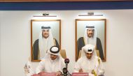 Qatar Basketball Federation President and LOC Director General Mohammed Saad Al Meghaiseeb (left) and Qatar Fund for Development Commenting Director General Khalifa Al Kuwari sign the Memorandum of Understanding.