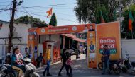 This photograph taken on March 19, 2024 shows people walking past the ruling Bharatiya Janata Party (BJP) office in Dehradun, in India's Uttarakhand state. (Photo by Amarjeet Kumar Singh / AFP)