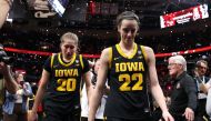 Caitlin Clark #22 and Kate Martin #20 of the Iowa Hawkeyes walk off the court after losing to the South Carolina Gamecocks in the 2024 NCAA Women's Basketball Tournament National Championship at Rocket Mortgage FieldHouse on April 07, 2024 in Cleveland, Ohio. (Photo by Steph Chambers / GETTY IMAGES NORTH AMERICA / Getty Images via AFP)
