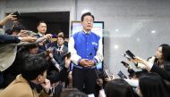 South Korea's main opposition Democratic Party (DP) leader Lee Jae-myung speaks to reporters after watching TVs broadcasting the results of exit polls for the parliamentary election at the National Assembly in Seoul on April 10, 2024. (Photo by Chung Sung-Jun / POOL / AFP)