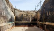 This handout picture released by the archaelogical park of Pompeii on April 11, 2024 shows new frescoes in a banqueting room with black walls part of the ongoing excavations in the block 10 of Regio IX, in Pompeii, near Naples. (Photo by Handout / Parco Archeologico di Pompei press office / AFP) 
