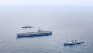 This handout photo taken on April 11, 2024 and provided by the South Korean Defence Ministry shows the US Navy's USS Theodore Roosevelt aircraft carrier (C), South Korean Navy's destroyer ROKS Seoae Ryu Seong-ryong (bottom) and Japanese Maritime Self-Defense Force destroyer JS Ariake (top) sailing in formation during a joint maritime drill in international waters south of the southern Jeju island. (Photo by Handout / South Korean Defence Ministry / AFP)