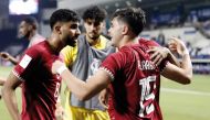 Qatar's Ahmed Al Rawi celebrates with team-mates after scoring the team's second goal against Indonesia yesterday.  Pics: Rajan Vadakkemuriyil / The Peninsula
