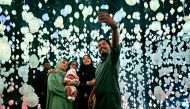 Wajeeha Latheef and family pose for a picture after exploring 'Your Brain to Me, My Brain to You' exhibition at NMOQ on April 26, 2024. Pic: Marivie Alabanza / The Peninsula