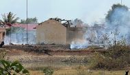 Smoke billows from the warehouse following an explosion at an army base in Kampong Speu province on April 27, 2024. (Photo by AFP)
