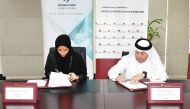 QC Director of Administrative and Finance Department, Hussain Yousef Al Abdullghani, and CEO of Pioneers Training Centre, Noor Mohamed Al Mansoori, signing the agreement.