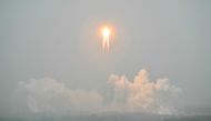 A Long March 5 rocket, carrying the Chang'e-6 mission lunar probe, lifts off as it rains at the Wenchang Space Launch Centre in southern China's Hainan Province on May 3, 2024. Photo by HECTOR RETAMAL / AFP