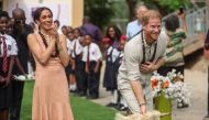 Britain's Prince Harry (R), Duke of Sussex, and Britain's Meghan (L), Duchess of Sussex, take part in activities as they arrive at the Lightway Academy in Abuja on May 10, 2024 as they visit Nigeria as part of celebrations of Invictus Games anniversary. (Photo by Kola SULAIMON / AFP)
