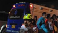 A member of the Red Cross works at the scene of an explosion at a gunpowder factory in Soacha, south of Bogota, on May 22, 2024. Photo by Andrea ARIZA / AFP