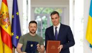 Ukraine's President Volodymyr Zelensky and Prime Minister Pedro Sanchez pose for photographs after signing a security deal at La Moncloa Palace in Madrid on May 27, 2024. (Photo by Oscar Del Pozo / AFP)
 
