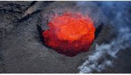 Picture taken with a drone on April 13, 2024 at Svartsengi near Grindavik, Iceland, shows an aerial view of a volcanic eruption at Sundhnukagigar in southwest Iceland, ongoing for a month. Photo by Jeremie RICHARD / AFP