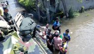  A soldier distributes food to people affected by the floods in Colombo, Sri Lanka, on June 4, 2024. (Photo by Ajith Perera/Xinhua)
 