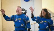 NASA astronauts Butch Wilmore (L) and Suni Williams, wearing Boeing spacesuits, wave as they prepare to depart the Neil A. Armstrong Operations and Checkout Building at Kennedy Space Center for Launch Complex 41 at Cape Canaveral Space Force Station in Florida to board the Boeing CST-100 Starliner spacecraft for the Crew Flight Test launch , on June 5, 2024. Photo by Miguel J. Rodriguez Carrillo / AFP.
 