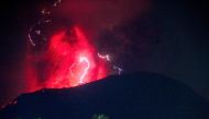 In this handout picture taken and released on June 6, 2024 by the Geological Agency lightning struck as lava erupts from the crater of Mount Ibu, as seen from West Halmahera, North Maluku. Photo by Handout / Geological Agency / AFP.