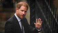 File: Britain's Prince Harry, Duke of Sussex waves as he arrives at the Royal Courts of Justice, Britain's High Court, in central London on March 28, 2023. (Photo by Daniel Leal / AFP)
