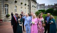 US WWII veteran Harold Terens, 100, (L) and Jeanne Swerlin, 96, (R) gesture as they arrive for their wedding in Normandy on June 8, 2024 (Photo by Loic Venance / AFP)