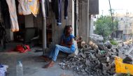 A displaced Palestinian girl sits in a damaged building in which she took refuge in al-Bureij refugee camp in the central Gaza Strip on June 12, 2024. (Photo by Eyad Baba / AFP)