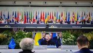 Ukraine's President Volodymyr Zelensky is seen on a screen during a plenary session at the Summit on peace in Ukraine, at the luxury Burgenstock resort, near Lucerne, on June 16, 2024.  (Photo by Urs Flueeler / POOL / AFP)
