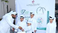 An official distributes gift to children during the Eid celebrations.