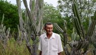 Alcides Peixinho Nascimento walks at his plantation of mandacaru —also known as cardeiro (Cereus jamacaru)— in Serra da Canabrava, Bahia State, Brazil on June 12, 2024. (Photo by Pablo Porciuncula / AFP)