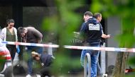 Police officers are at work on the site of a shooting that occured overnight during a wedding party in Thionville, eastern France, on June 30, 2024. (Photo by Jean-Christophe Verhaegen / AFP)
 