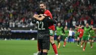 Portugal's goalkeeper #22 Diogo Costa and midfielder #10 Bernardo Silva celebrate their win at the end of the UEFA Euro 2024 round of 16 football match between Portugal and Slovenia at the Frankfurt Arena in Frankfurt am Main on July 1, 2024. (Photo by JAVIER SORIANO / AFP)
