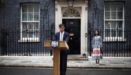 Britain's outgoing Prime Minister and leader of the Conservative party, Risihi Sunak, watched by his wife Akshata Murty, delivers a statement after his general election defeat, outside 10 Downing Street in London on July 5, 2024, a day after Britain held a general election. (Photo by Henry Nicholls / AFP)