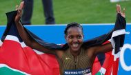 Kenya's Faith Kipyegon reacts after winning and beating the world record in the women's 1500m during the 