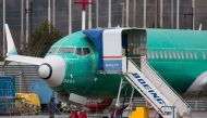 File: A person walks past an unpainted Boeing 737-8 MAX parked at Renton Municipal Airport adjacent to Boeing's factory in Renton, Washington on January 25, 2024.  (Photo by Jason Redmond / AFP)
