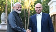 In this pool photograph distributed by the Russian state agency Sputnik, Russia's President Vladimir Putin welcomes Indian Prime Minister Narendra Modi for an informal meeting at the Novo-Ogaryovo state residence, outside Moscow, on July 8, 2024. (Photo by Sergei BOBYLYOV / POOL / AFP)