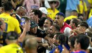 Colombia's supporters (L) clash with Uruguay's supporters, alongside Uruguay's defender #04 Ronald Araujo (R) at Bank of America Stadium, in Charlotte, North Caroline on July 10, 2024. (Photo by Juan Mabromata / AFP)
