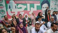 Supporters of former prime minister Imran Khan and his Pakistan Tehreek-e-Insaaf (PTI) party celebrate after a Supreme Court verdict, in Karachi on July 12, 2024. (Photo by Asif HASSAN / AFP)
