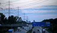 Vehicles drive on A5 motorway during sunset outside Frankfurt am Main, western Germany, on July 8, 2024. (Photo by Kirill Kudryavtsev / AFP)  