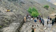 Afghan residents shovel mud following flash floods after heavy rainfall at Pesgaran village in Dara district, Panjshir province on July 15, 2024. At least 35 people were killed and 230 injured on July 15, after heavy rain in eastern Afghanistan, a local official said. (Photo by AFP)
