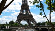 A Seine river bus boat docks in front the Eiffel Tower adorned with Olympic rings ahead of the Paris 2024 Olympic and Paralympic Games in Paris in July 16, 2024 (Photo by EMMANUEL DUNAND / AFP)
