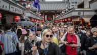 This file photo taken on April 30, 2024 shows tourists walking through Nakamise shopping street near Sensoji Temple in Tokyo. Photo by Yuichi YAMAZAKI / AFP