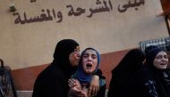 Palestinian women cry as killed members of the Abu Taha family are brought for burial, outside Nasser hospital in Khan Yunis following Israeli bombardment east of the city in the southern Gaza Strip on July 22, 2024. (Photo by Bashar Taleb / AFP)
