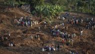 Residents and volunteers dig in the mud in search for survivors and bodies at the scene of a landslide in Gofa on July 24, 2024. (Photo by Michele Spatari / AFP)
